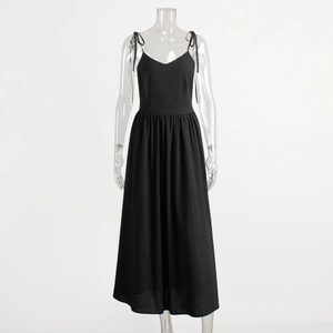 Close-up detail of the black cotton V-neck dress showing fabric texture and thin straps