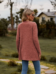 Rear view of a dusty rose ribbed knit long sleeve cardigan showing drape and texture