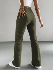 Detail of army green ribbed knit flare pants with high-waisted cut and slim fit silhouette