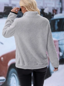 Detail view showing the plush fleece texture and black piping on light gray pullover back