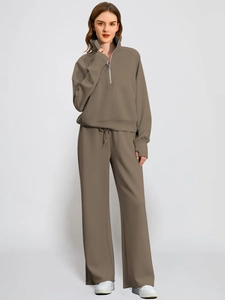 Detail of a two-piece leisure set featuring a half-zip stand collar and kangaroo pocket
