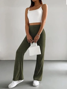 Detail view of olive green ribbed knit flared pants with high waist for a slim fit look