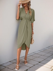 Detail of olive green V-neck dress featuring knotted waist and asymmetrical hemline