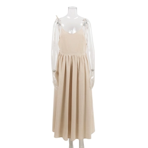 Detailed view of beige V-neck cotton dress with waist pleats on transparent mannequin
