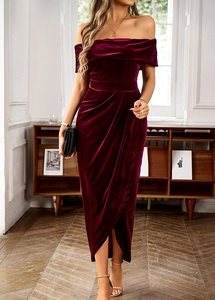 Macro detail of wine red velvet dress showing off-shoulder cut and soft fabric texture