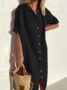 Close-up of black cotton linen shirt dress with white round buttons and textured fabric
