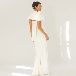 Detail of elegant cream bodycon maxi dress featuring textured fabric and draped back detail