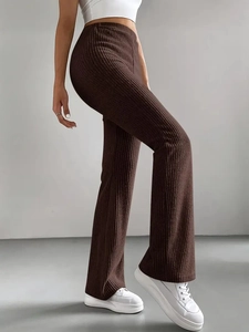 Detail view of chocolate brown ribbed knit flare pants showing the textured fabric and fit