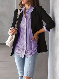 Detail showing a purple striped shirt under a black blazer with light blue ripped jeans