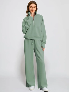 Sage green women's two-piece tracksuit with half-zip sweatshirt and wide-leg joggers
