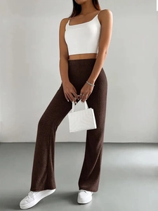 Detail of dark brown ribbed knit flare pants featuring high waist slim fit design