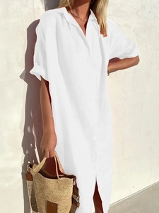 Detail view of white cotton linen shirt dress with button-up front and classic collar