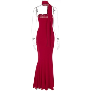 Detail of red fishtail dress featuring slim-fit cut and decorative flowing back ribbon