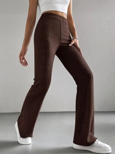 Close-up of brown ribbed knit texture on high-waisted flare pants with a slim fit design