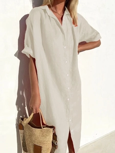 Detail shot of cream cotton linen shirt dress with button closure and rolled sleeves