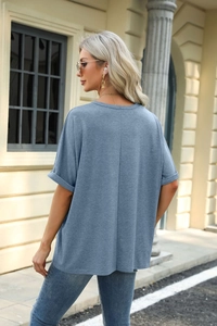 Detail view of fog blue crewneck T-shirt showing rolled cuffs and back seam stitch