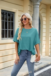 Detail of teal crew neck t-shirt with rolled cuff sleeves and casual outdoor styling