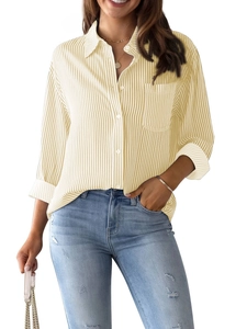 Detail showing the light yellow vertical striped texture and front pocket of the casual shirt