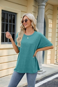 Detail of teal crew neck loose fit t-shirt fabric texture and drop shoulder design