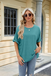 Close-up of teal loose-fit T-shirt with rolled sleeves and casual streetwear styling