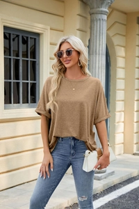 Detail view of brown knit t-shirt featuring rolled cuffs and a classic crew neckline