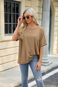 Outdoor close-up of a brown oversized crewneck t-shirt with loose drop shoulders