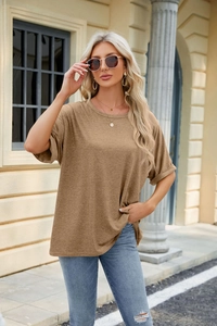 Close-up of brown loose fit T-shirt with drop shoulders and subtle fabric texture