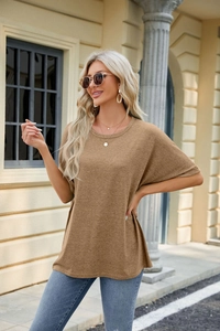 Detail of camel oversized drop-shoulder T-shirt with soft knitted texture on female model