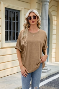 Outdoor shot of a khaki round neck t-shirt with rolled sleeves and denim jeans