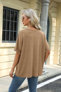 Detail showing the rolled sleeve and loose back fit of a khaki round-neck T-shirt for women