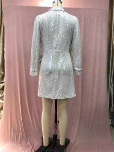 Rear view of silver sequin mini dress featuring long sleeves and a tailored V-neck cut
