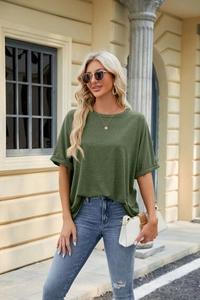 Detail view of dark green loose t-shirt showing the rolled sleeve and knit fabric texture
