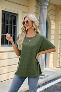 Close-up of dark green crew neck T-shirt fabric texture and loose drop shoulder design