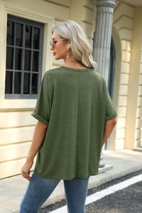 Detail view of dark green loose t-shirt with rolled cuffs and center back seam