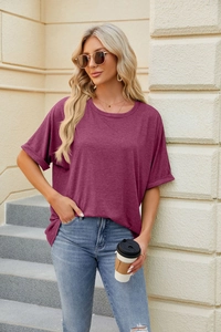 Close-up of fuchsia crew neck T-shirt featuring rolled cuffs and soft breathable fabric