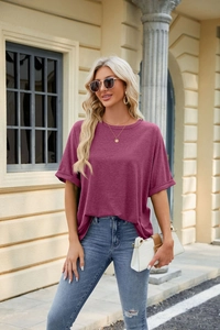 Close-up of berry red loose crewneck t-shirt with rolled sleeves and drop shoulder detail