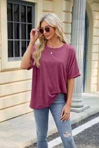 Outdoor shot of a casual loose fit crew neck t-shirt in deep purple paired with denim