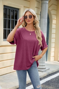Detail of plum-colored loose crew neck T-shirt with rolled cuff sleeves and knit texture