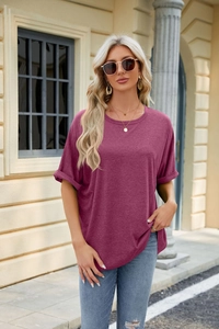 Detail of rolled cuffs on a loose-fit magenta cotton T-shirt for outdoor casual wear