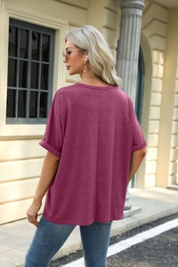 Detail of loose wine red t-shirt with back vertical seam and rolled cuffs