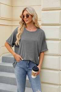 Detailed view of rolled cuffs and loose fit on a gray cotton oversized t-shirt