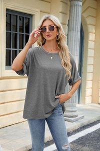 Close-up of a grey crewneck T-shirt showing rolled cuffs and premium cotton texture