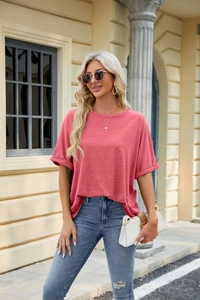 Detail of dry rose pink T-shirt featuring rolled cuffs and subtle melange texture