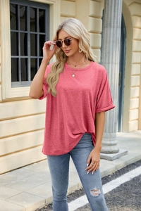 Detail shot of the pink crewneck T-shirt showing soft cotton texture and rolled sleeve cuffs