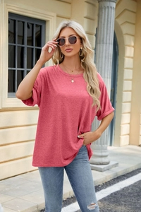 Detail of coral red loose fit cotton t-shirt paired with classic blue denim jeans