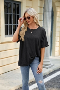 Detail shot of woman in black crew neck short sleeve tee and ripped jeans outdoor