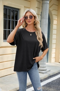 Detail of oversized black crew neck t-shirt with drop shoulders and soft cotton texture