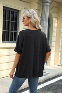 Detail of loose black short sleeve T-shirt with rolled cuffs and vertical back seam detail