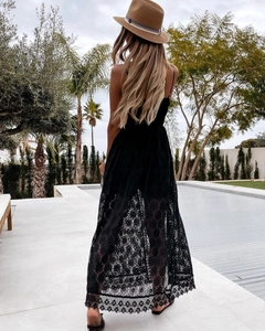 Detailed close-up of intricate hollow floral lace on a black sleeveless vacation maxi dress