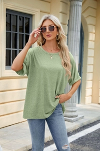 Detail view of light green oversized crewneck T-shirt with rolled sleeves and drop shoulder